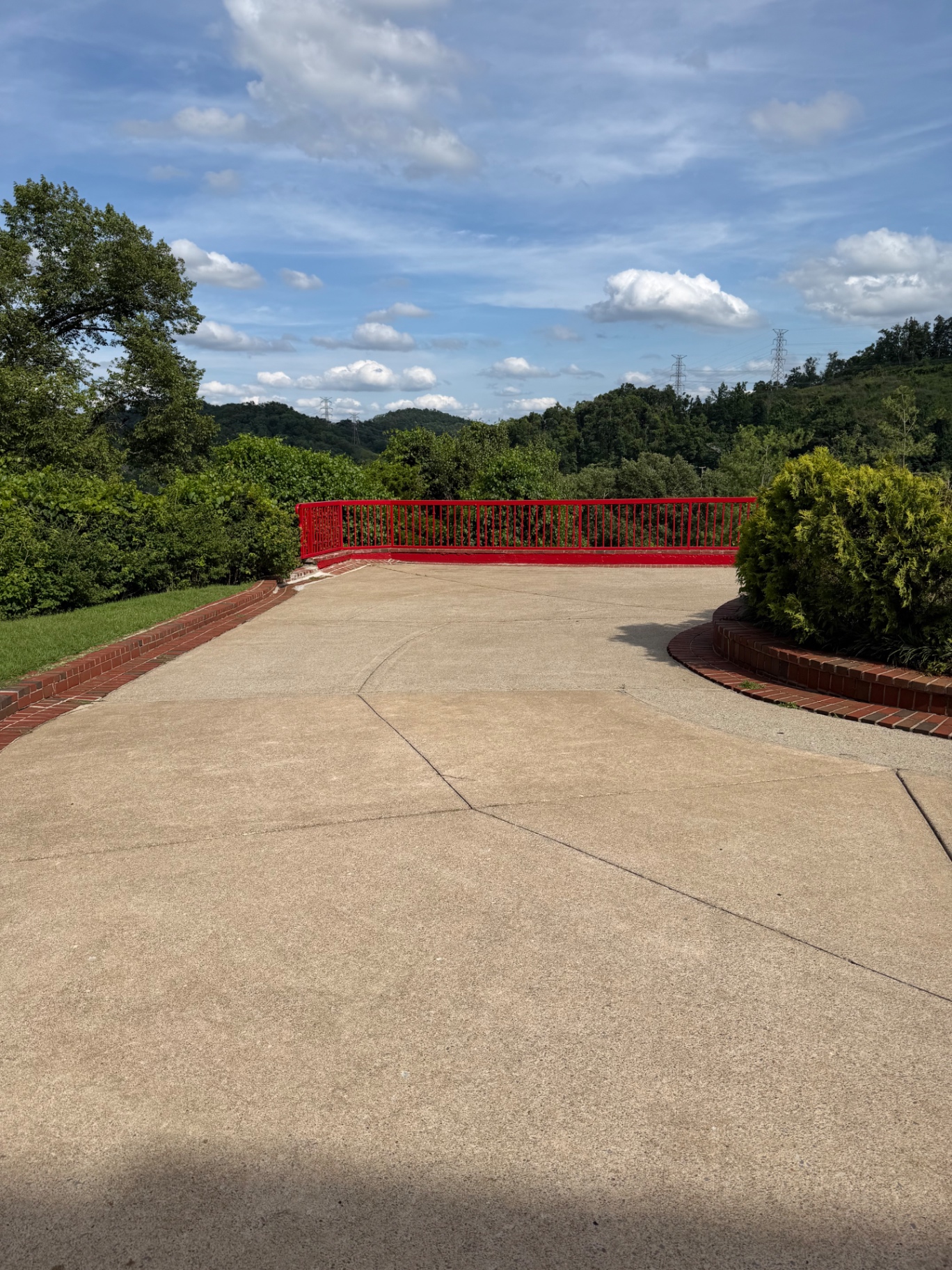 Before and after of a lower driveway curve cleaning project